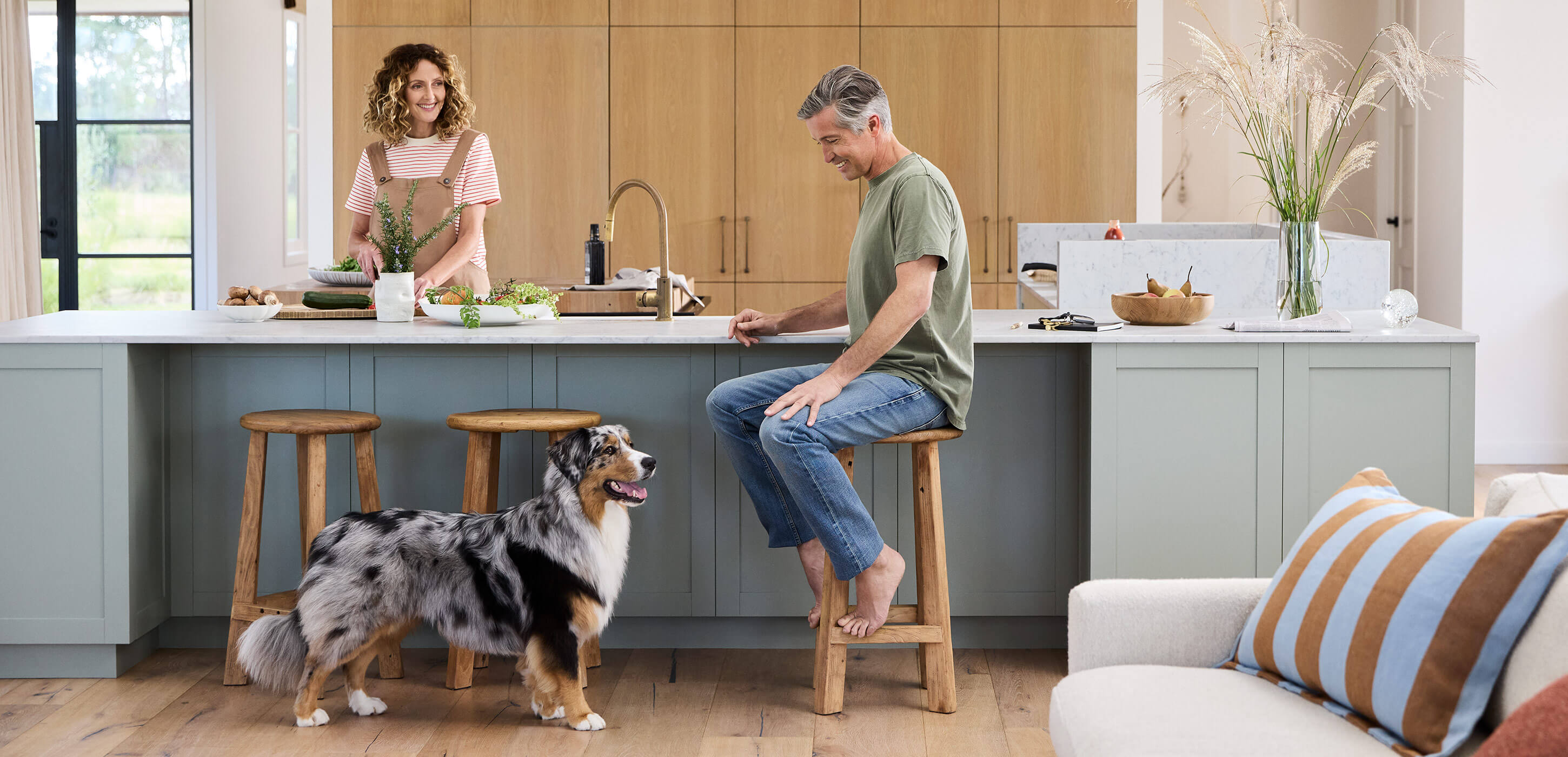 a couple with their dog enjoying the kitchen space